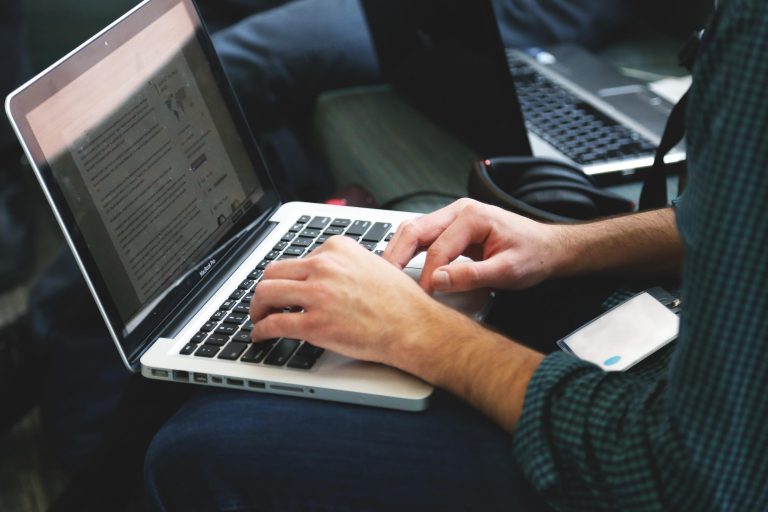Hands using a MacBook Pro for The IT Guys service article