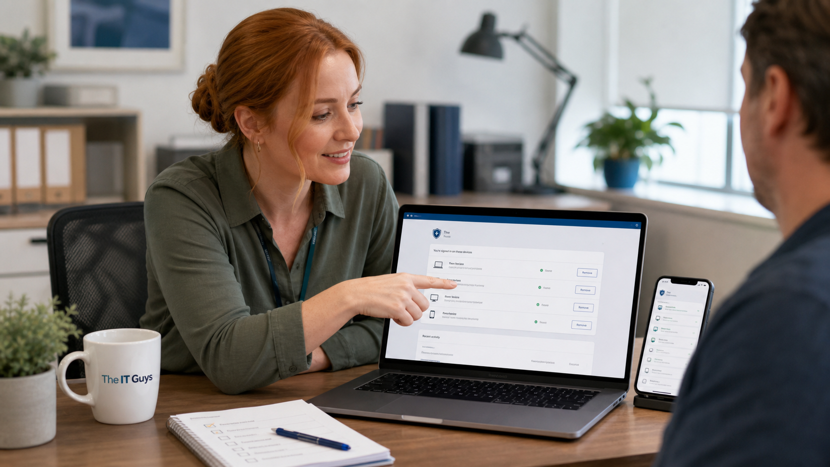 Jennifer helping a customer review signed-in devices on a laptop and phone