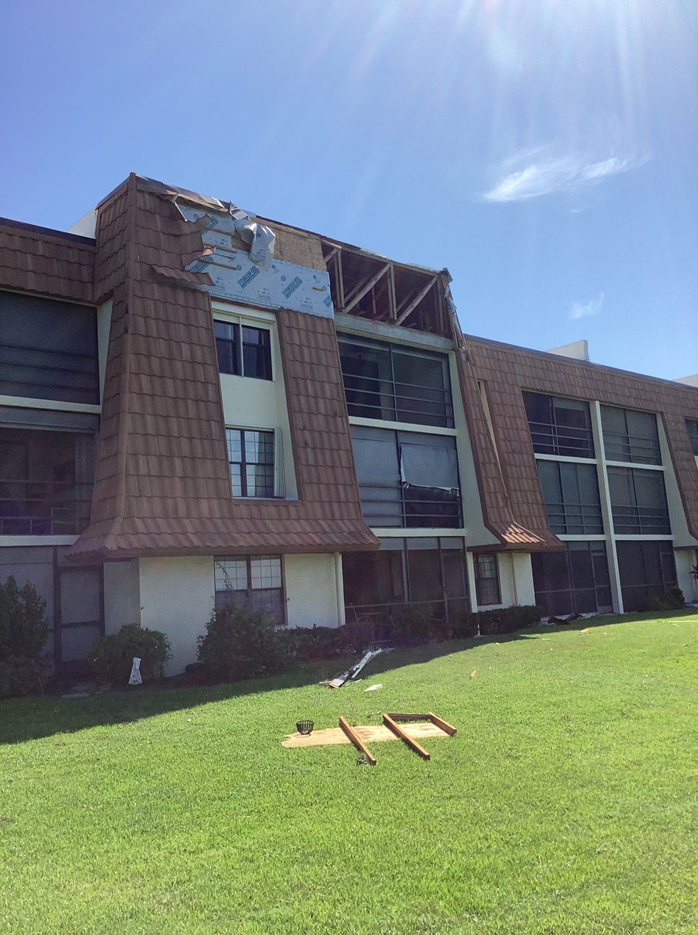 Exterior roof-edge damage on a low-rise residential building after the Port St. Lucie EF-0 tornado.
